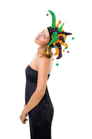 Young woman stand wearing jester hat and black one-piece suit standing in profile and smileの写真素材