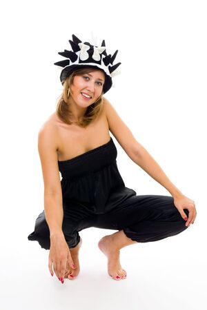 Young woman squat in football fan hat and smiling front view isolated on whiteの写真素材