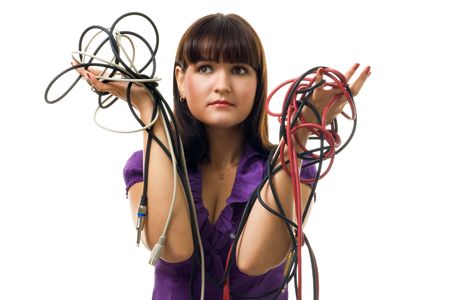 Young woman hold wires and have problems what to do with them,isolated on whiteの写真素材