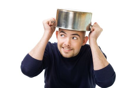 Man afraid and protecting his head holding casserole,isolated on whiteの写真素材
