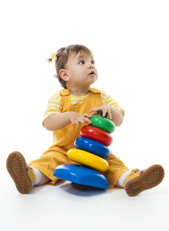 Baby girl play with pyramid isolated on whiteの写真素材
