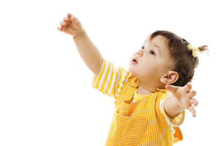 Toddler learn to walk dressed in yellow pajamas, isolated on whiteの写真素材