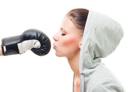 Beautiful woman kiss boxing glove representing love to fights and sport,isolatedの写真素材