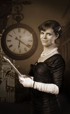 Old style woman with clock in background hold paperの写真素材