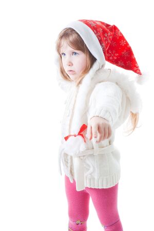 little girl in santa cap point away with fingerの写真素材