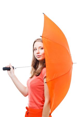 Young woman hide behind big orange umbrellaの写真素材