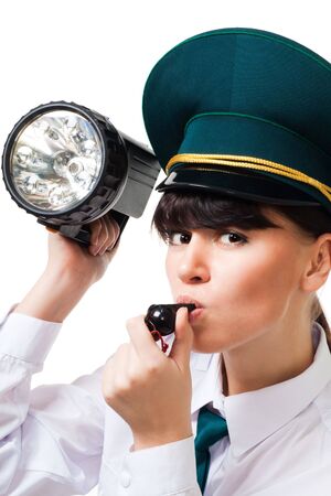Woman from customs control holding whistle and flashlightの写真素材