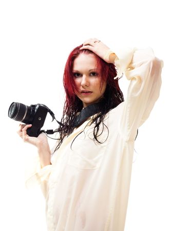 Attractive woman with photo camera  in wet clothes, isolated on whiteの写真素材