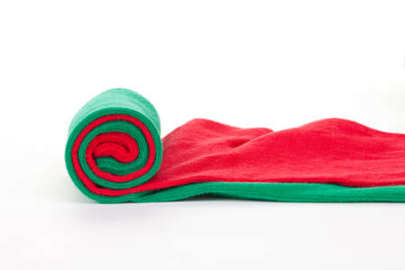 One green and red colorful textile fabric roll, isolated on whiteの写真素材