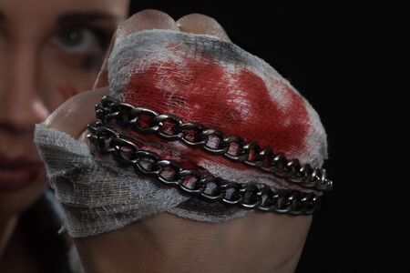 Fist and blood from fighting with metal chain on itの写真素材