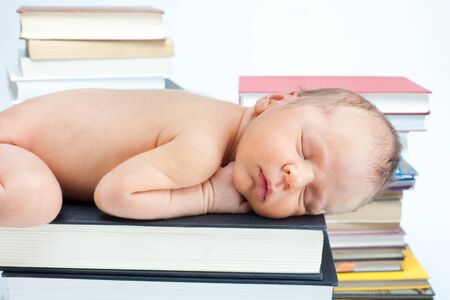 Close-up of newborn baby sleep on the books in the libraryの写真素材