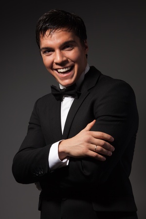 Confident business man laughing with positive expression looking at cameraの写真素材