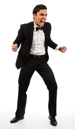 Extremely angry businessman part his hands with fists and roaring wearing a suitの写真素材