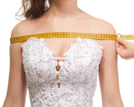 Measuring the size of the shoulders with centimeter, isolated on whiteの写真素材