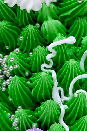 Close up of a green confectioner cake cream and decorationsの写真素材