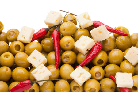 Pile of olives and chili pepper and sheep cheese on white backgroundの写真素材