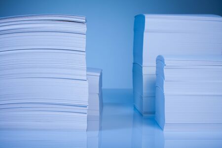 Many paper piles  on blue background