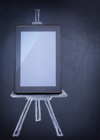 Tablet computer as easel on the blackboard with tripod and strobe drawn with chalkの写真素材