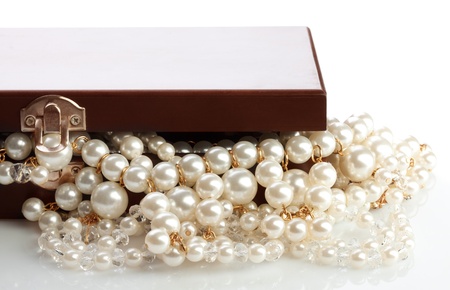 Wooded bow with jewelry and pearl necklace on whiteの写真素材
