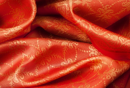 Folded orange fabric with Indian ornamentの写真素材