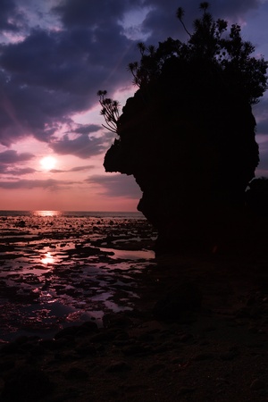 sunset in low tide in the rocky bay on the tropical islandの写真素材