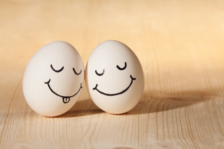 two eggs with drawn smiley facesの写真素材