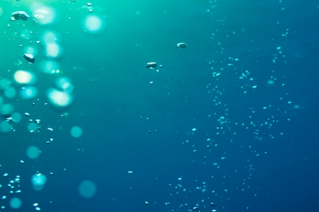 Underwater air bubbles getting to the surface backgroundの写真素材