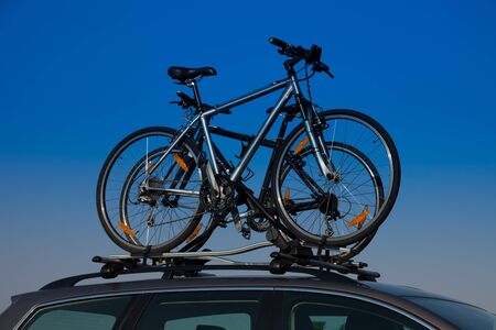 Bike transportation - two bikes on the roof of a carの写真素材