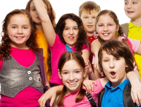 Close-up of a group of 8 kids together with backpacks, smiling, laughing, on whiteの写真素材