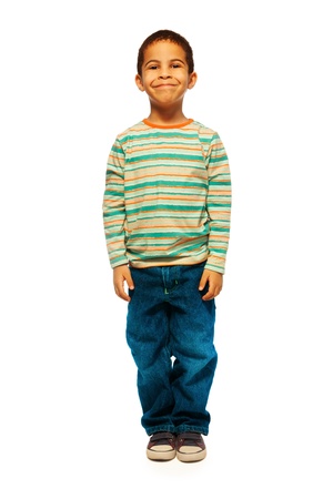 Full height portrait of cute black boy with smile on face standing isolated on whiteの写真素材