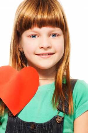 Smiling girl holding heart made of cardboard and smilingの写真素材