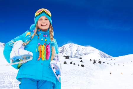 Happy 10 years old Caucasian girl with ice-skates outside on winter dayの写真素材