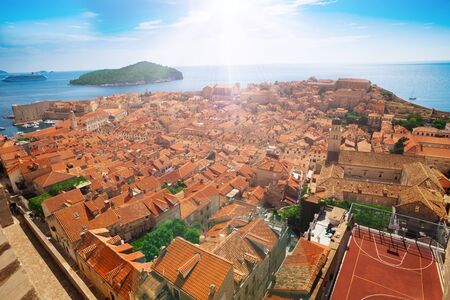 Old town red tile roofs of Dubrovnik with Lokrum island on backgroundの写真素材