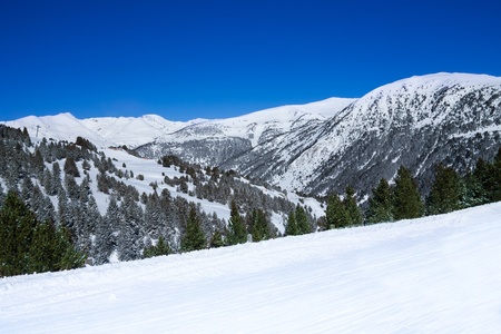 Mountain landscape background in ski resort with part of pisteの写真素材