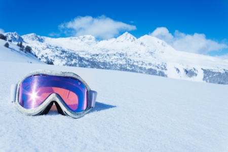 Ski and snowboard mask in the snow with copy space and mountain on backgroundの写真素材