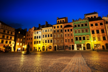 Warsaw old town marketplace square at night with colorful houses and stone pavement in Poland の写真素材