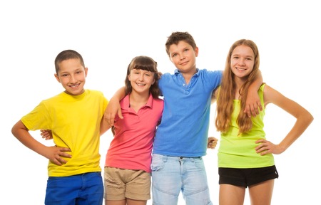 Group of four kids, boys and girls in colorful shirts hugging together