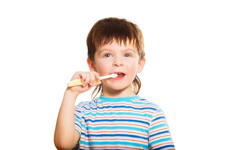 Close shoot of 3 years old boy brushing his teeth with toothbrush isolated on white