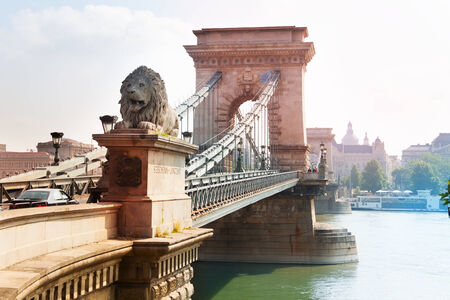 Chain bridge with monument of lion in in summer time in Budapest, Hungaryの写真素材