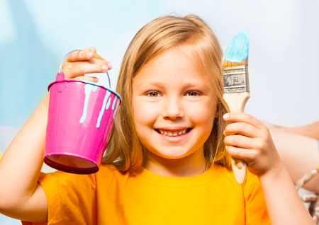 Happy little girl with painting accessoriesの写真素材