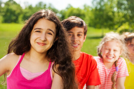Happy girl with long hair and her friendsの写真素材