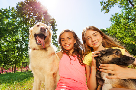 Happy girls and funny gods outside on sunny dayの写真素材