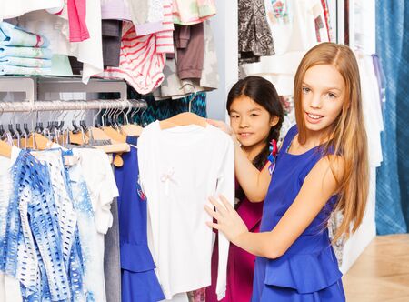 Two girls choosing the right item during shoppingの写真素材