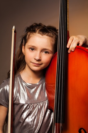 Girl with violoncello and string on gel backgroundの写真素材