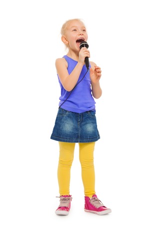 Girl singing karaoke in microphone and standingの写真素材