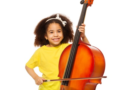 African girl plays violoncello with fiddlestickの写真素材