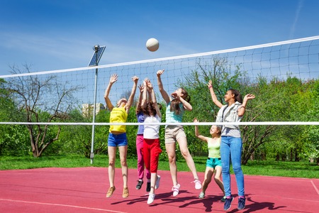 Teenagers team actively playing volleyball gameの写真素材