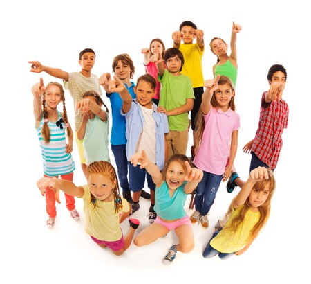 Bunch of diverse cute kids isolated on white standing and pointing at cameraの写真素材