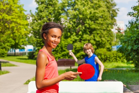 African girl playing  with boy outside during summer sunny dayの写真素材