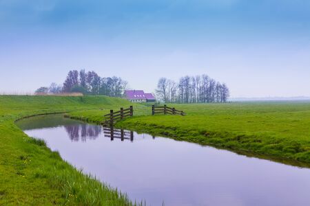 View of the river in the green field in Netherlands during summerの写真素材